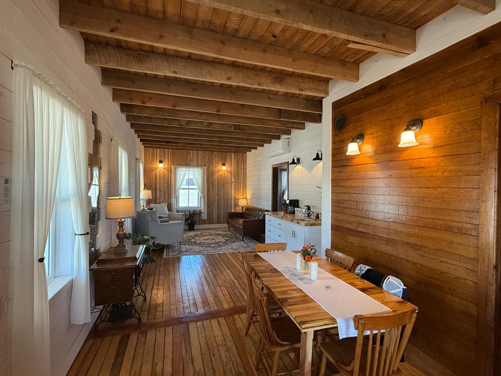 The restored interior of La Casa 1922 showing original timber beams and century-old wood floors